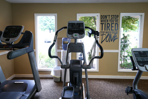 the fitness center has a treadmill and other exercise equipment