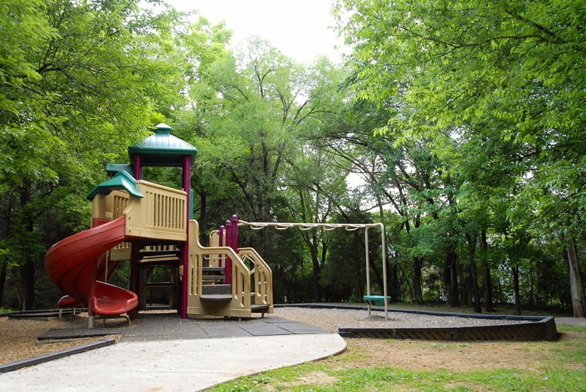 a playground with a slide and a swing set
