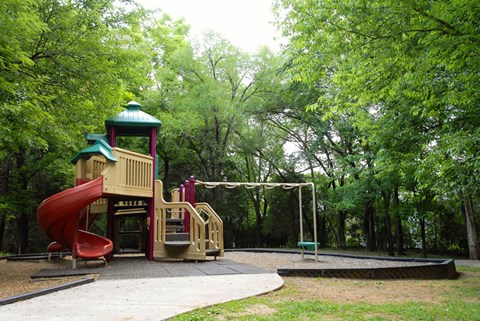 a playground with a slide and a swing set