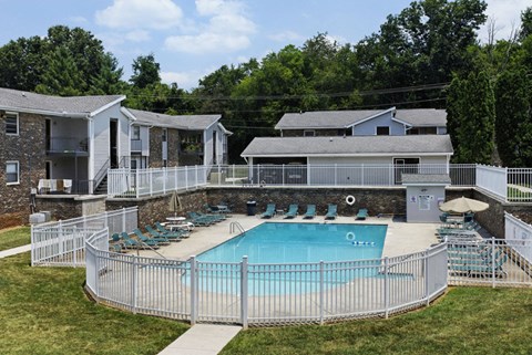 a resort style pool with a white fence around it