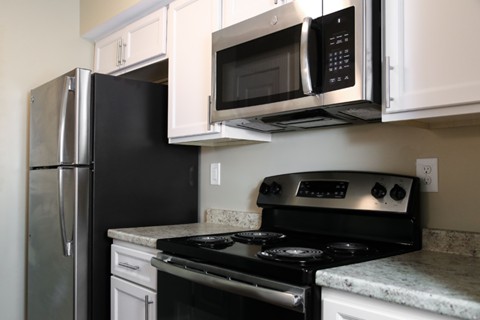 a kitchen with a stove microwave and refrigerator