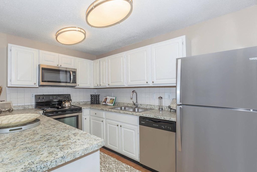 a kitchen with stainless steel appliances and granite counter tops