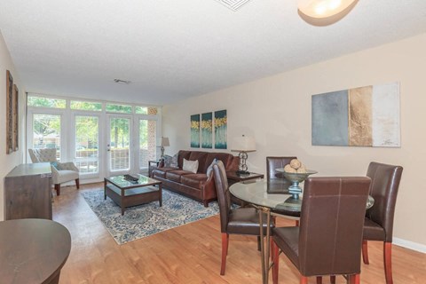 a living room and dining room with a table and chairs