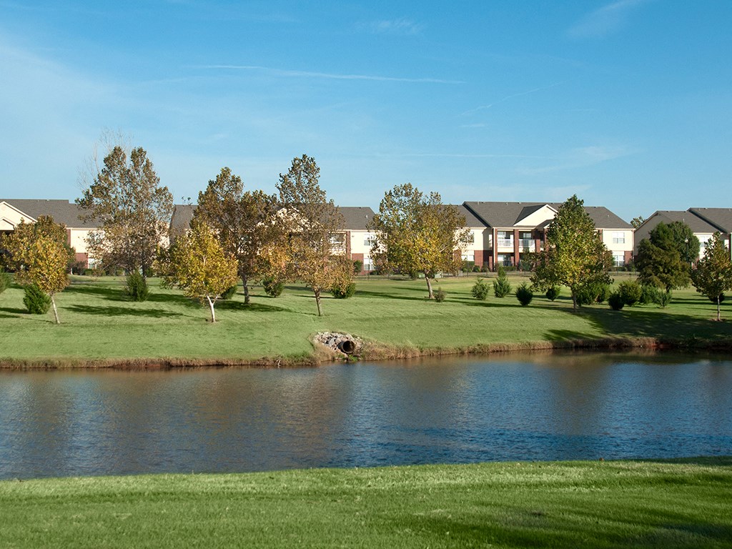 a body of water with houses in the background