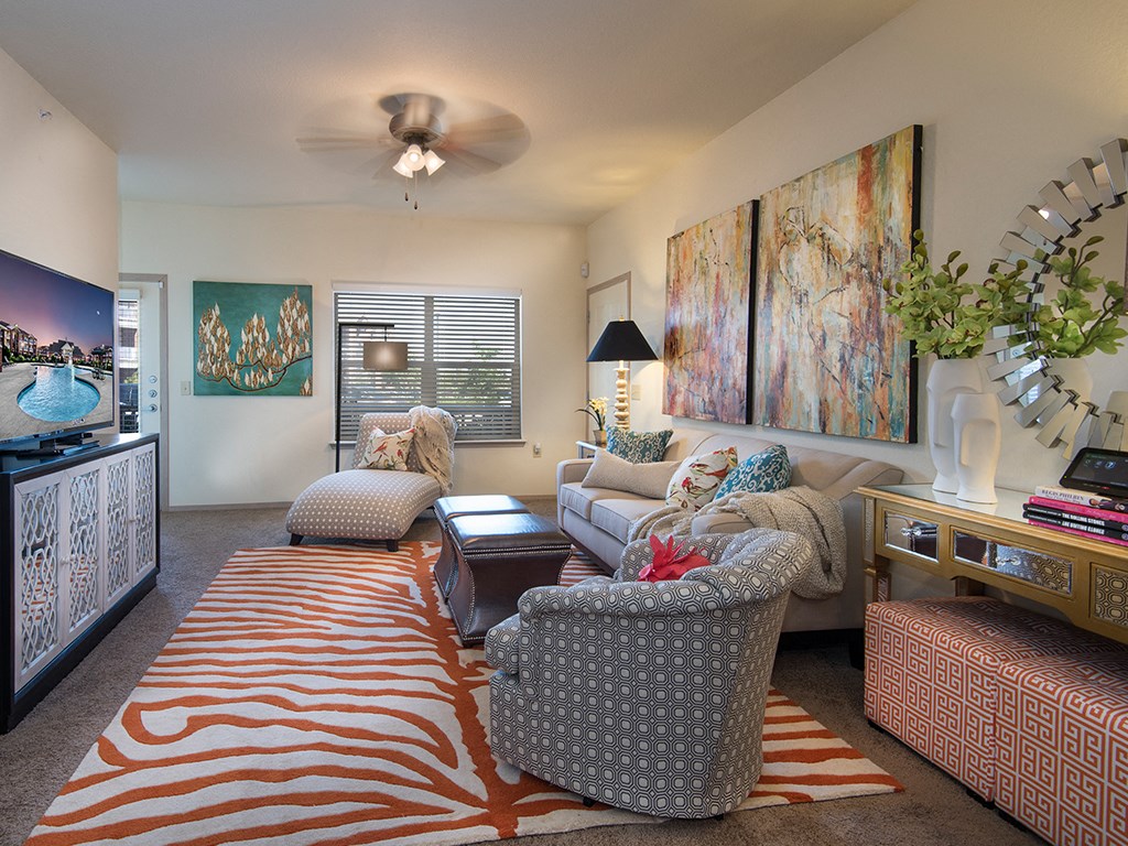 a living room with furniture and a ceiling fan