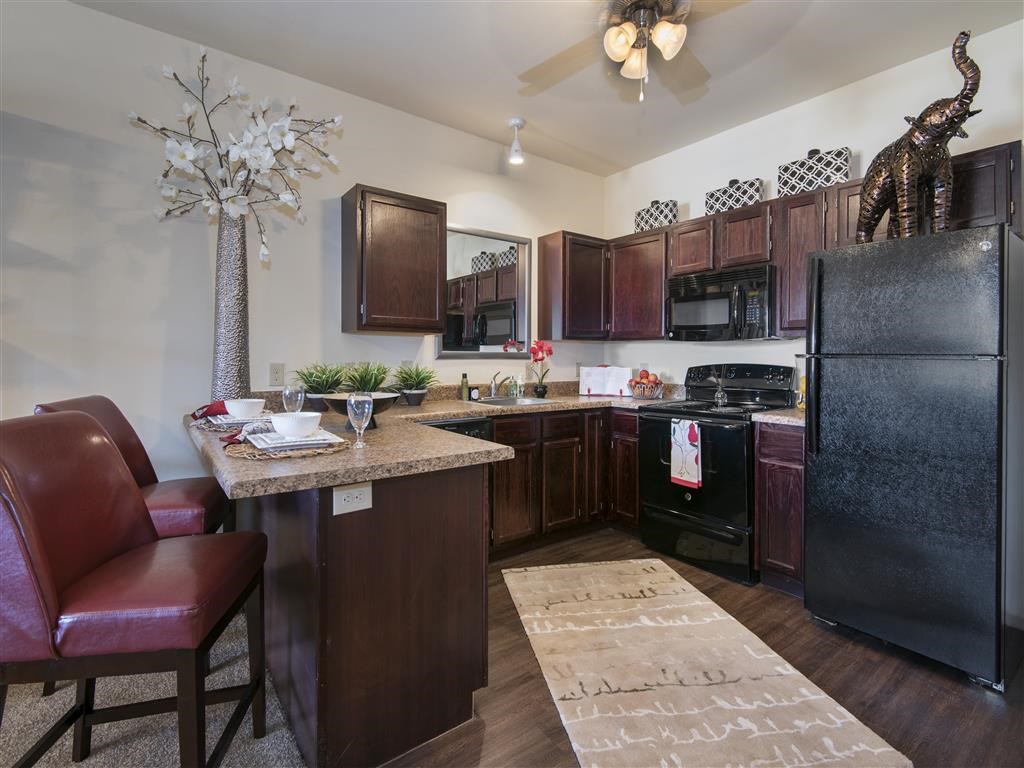 a kitchen with a counter top and a refrigerator