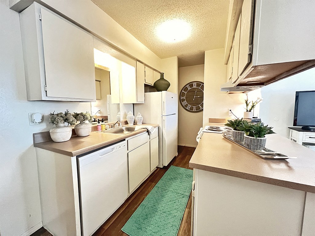 a kitchen with white cabinets and a counter top