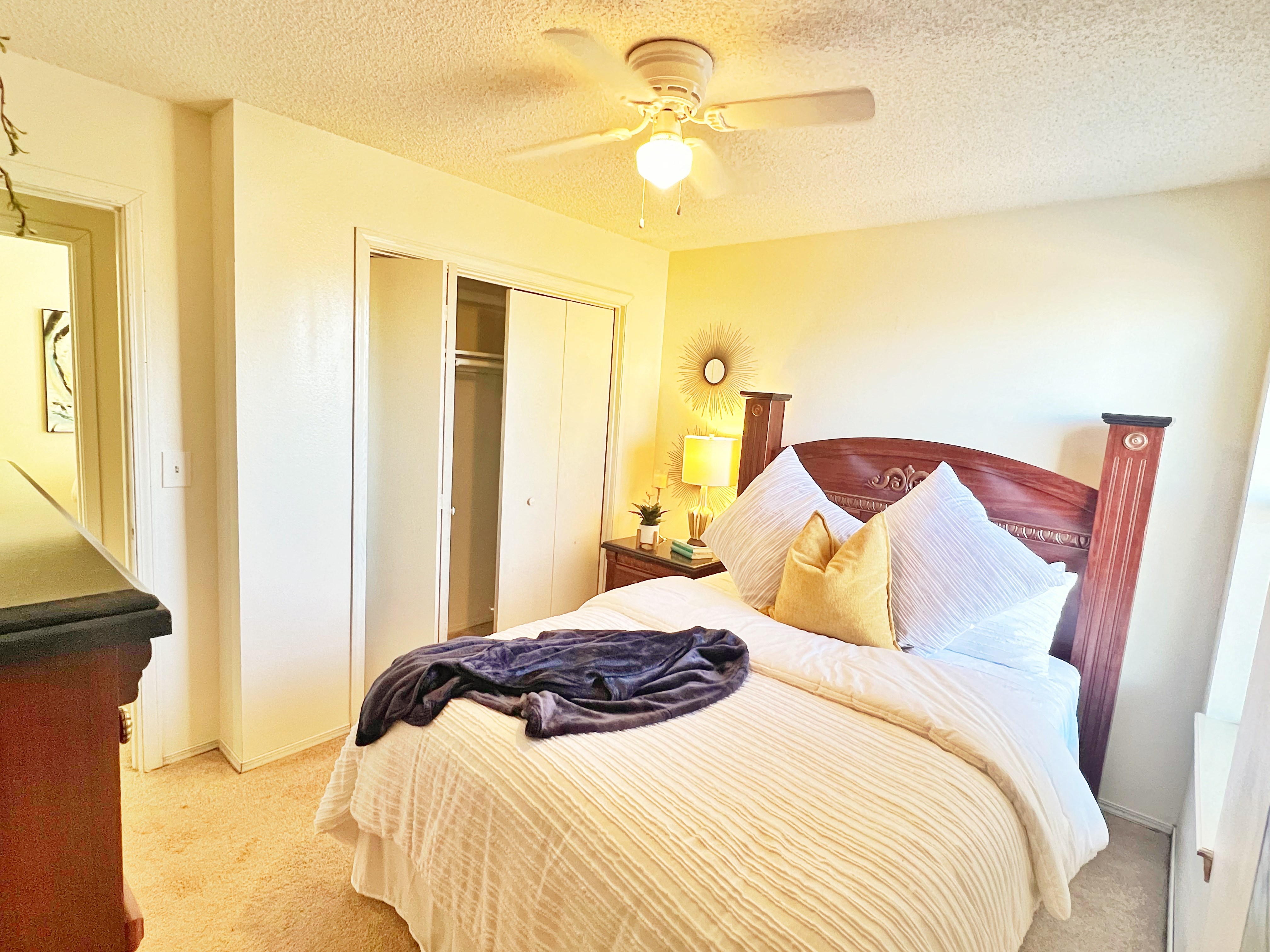a bedroom with a large bed and a ceiling fan