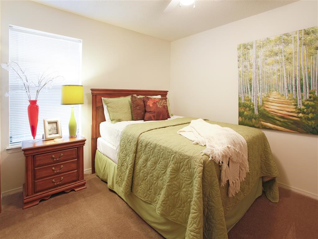 a bedroom with a bed and a dresser