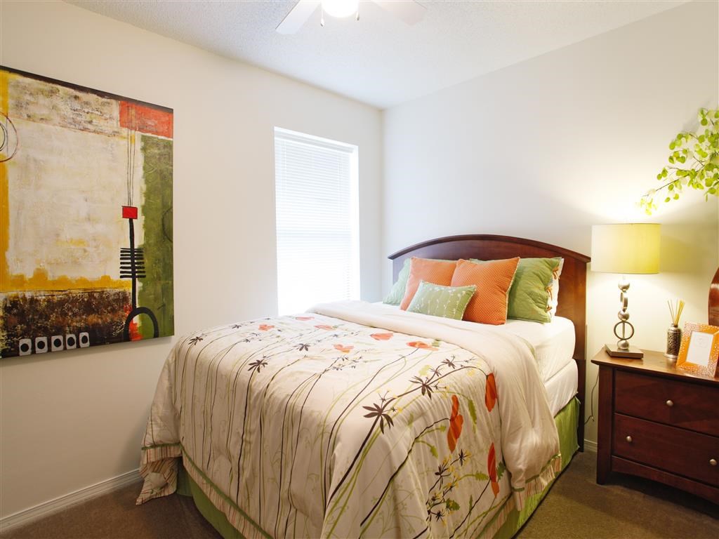 a bedroom with a bed and a painting on the wall