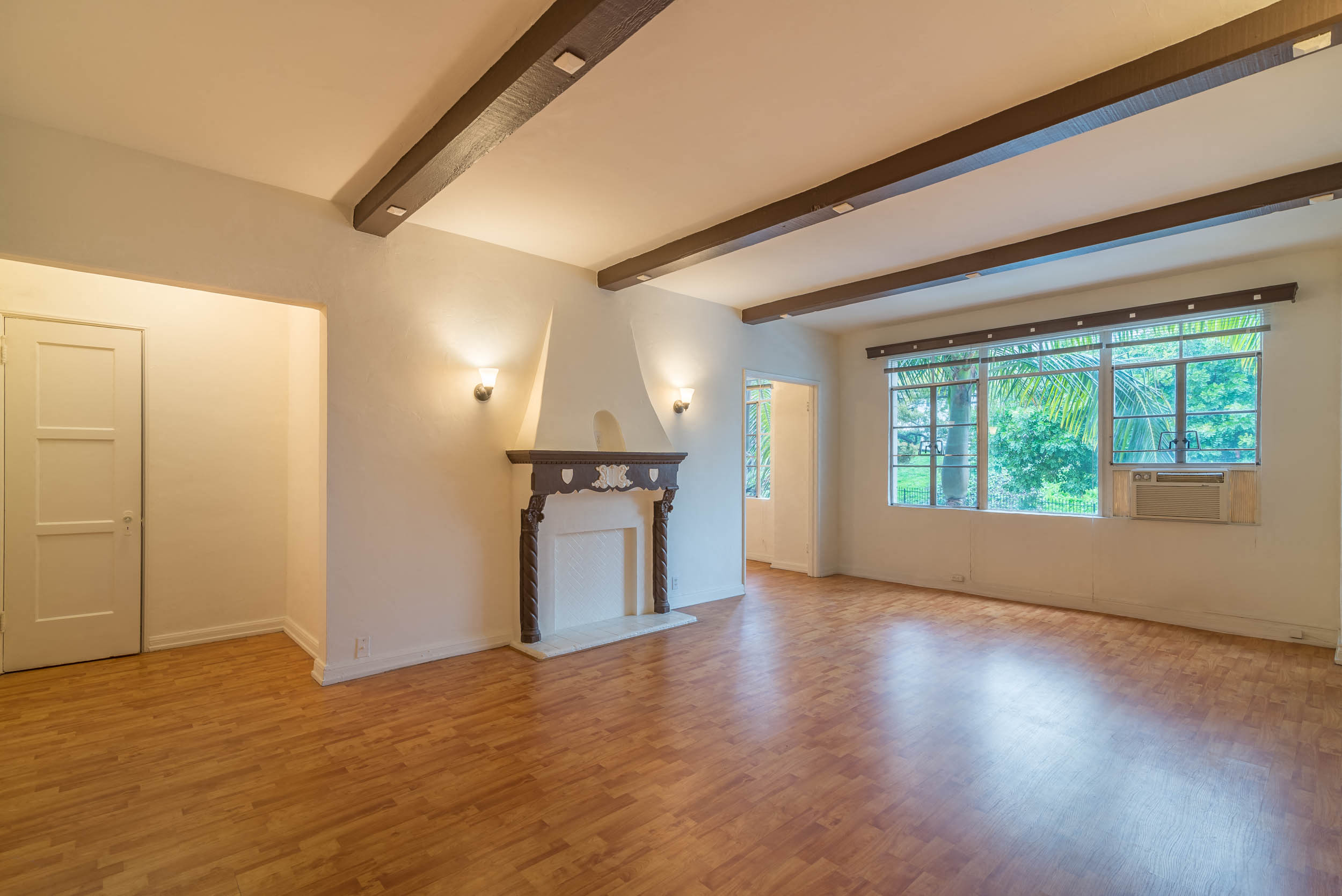 Living area with high beamed celing,  and balcony access