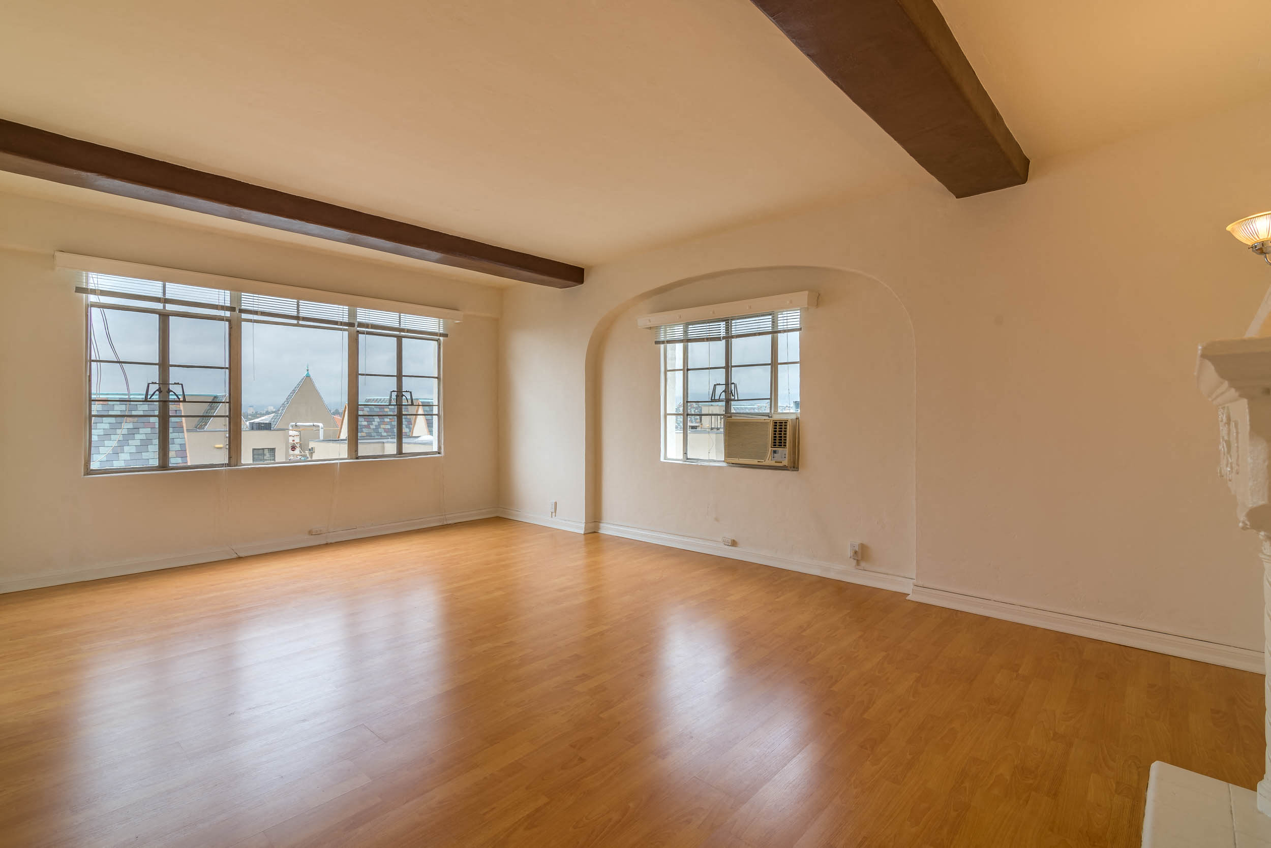 Living area with high beamed celing,  and balcony access