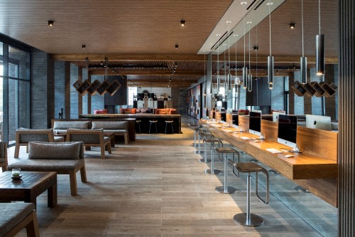 the lobby of a restaurant with tables and chairs