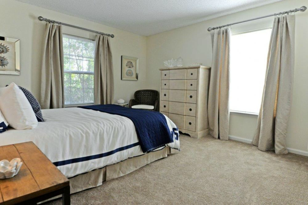 a bedroom with a bed and a dresser