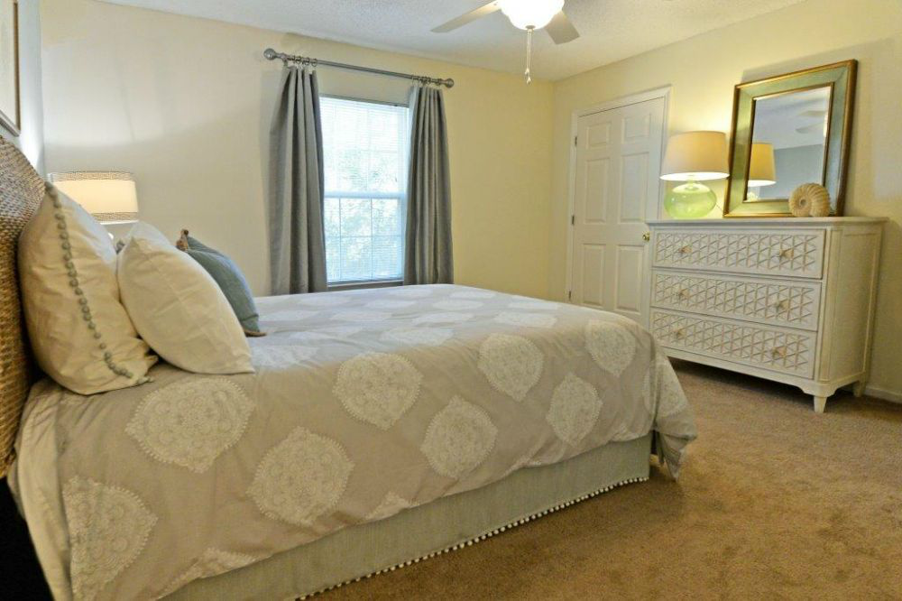 a bedroom with a large bed and a dresser