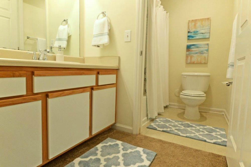 a bathroom with a toilet and a sink and a shower