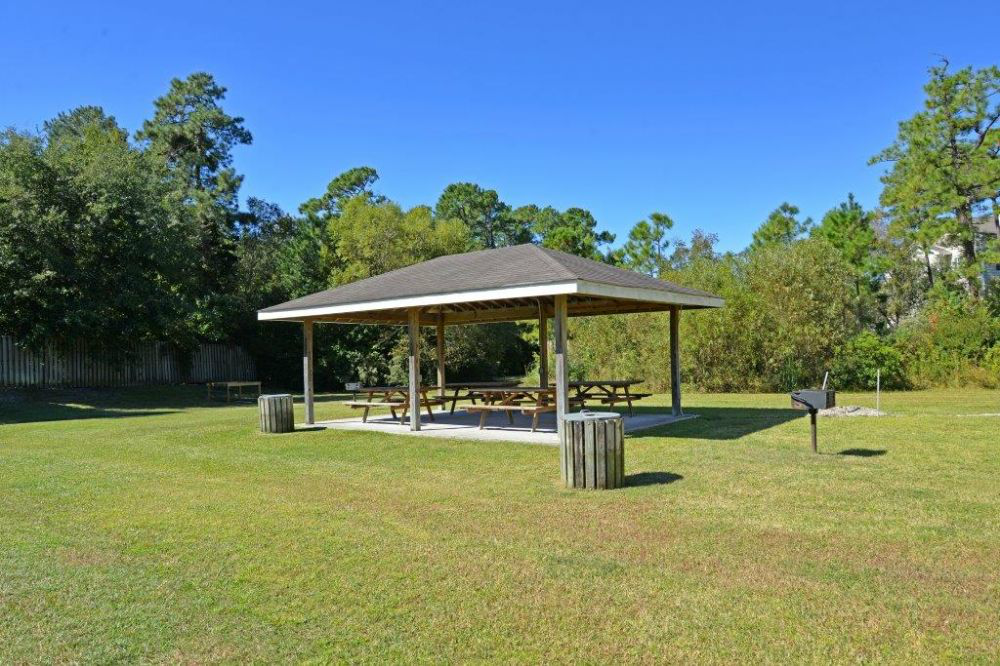 a pavilion with a picnic table in a park