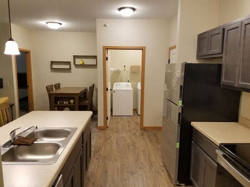 a kitchen with a sink and a refrigerator