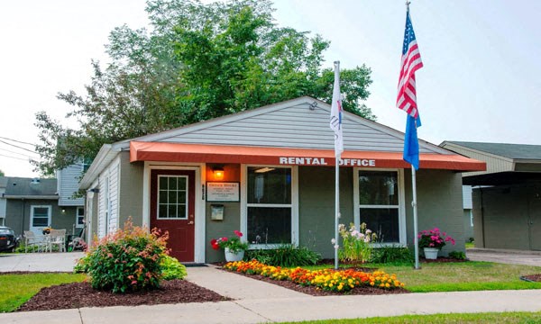 the rental office of a building with an flag in front of it