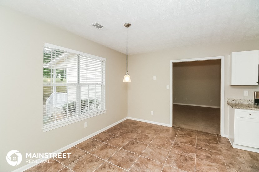 the living room and dining room of an apartment