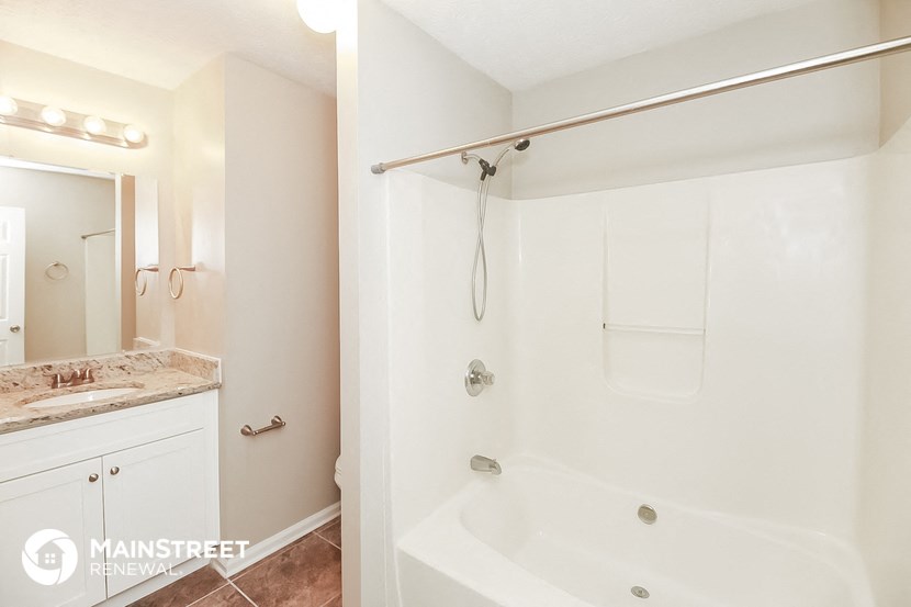 a bathroom with a shower and a sink and a bath tub