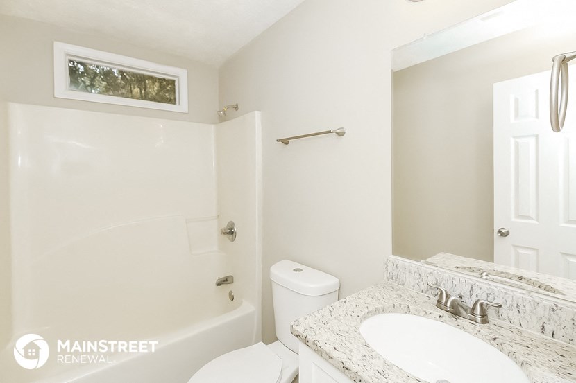a bathroom with a sink and a toilet and a bath tub