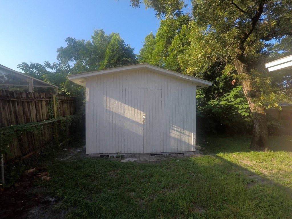a small white shed in the back yard