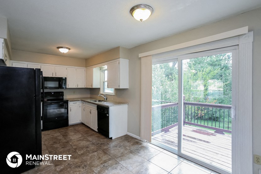the kitchen has a large sliding glass door to the balcony