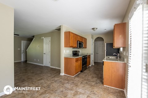 a kitchen with wooden cabinets and a counter top and a sink