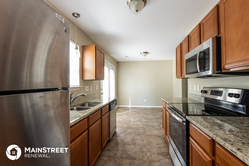 a kitchen with stainless steel appliances and wooden cabinets