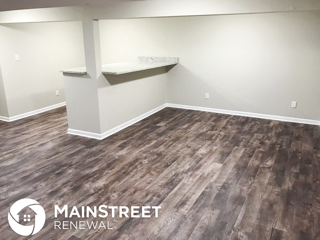 a room with vinyl flooring and a counter in the corner