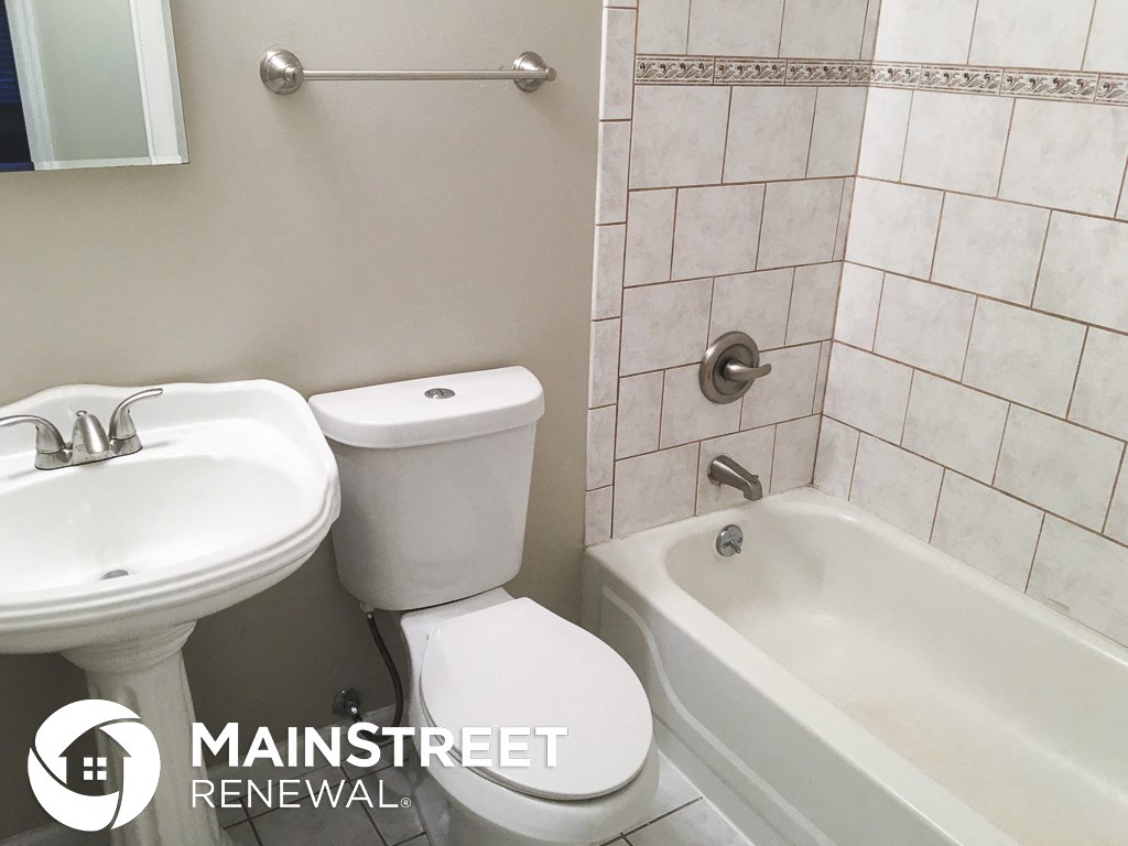 a small bathroom with a sink toilet and bath tub