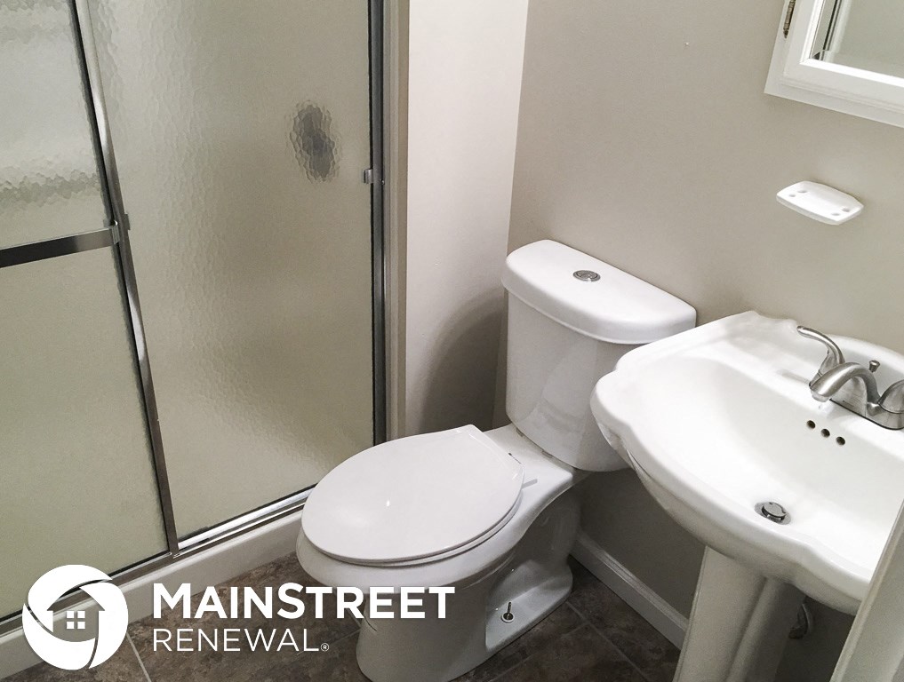 a small white bathroom with a toilet and a sink