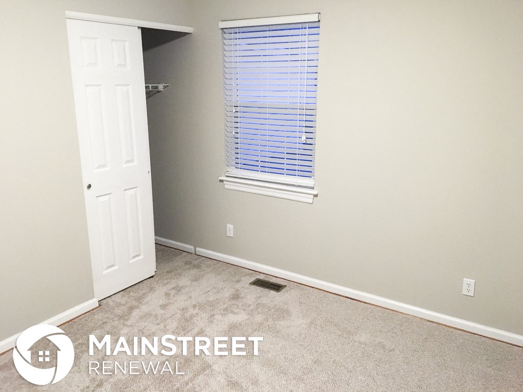 a room with a closet and a window and a door