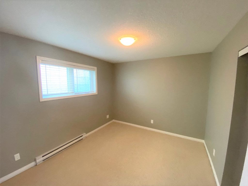 a empty room with a window and a light on the ceiling