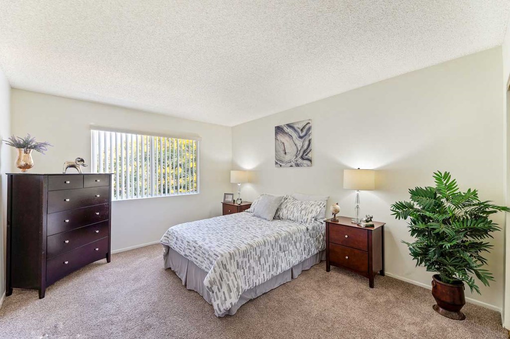 a bedroom with a bed and a dresser