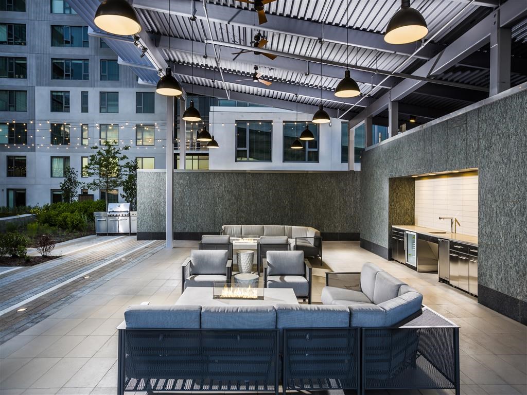 the lobby or reception area of a hotel with couches and chairs