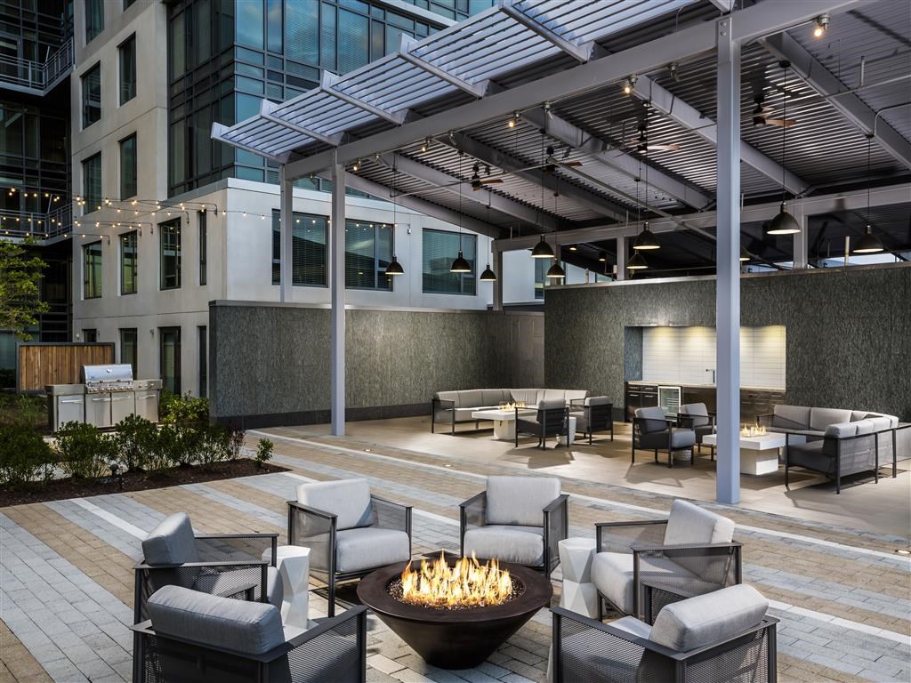 a lounge area with chairs and a fire pit