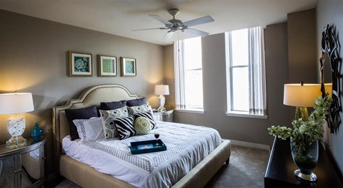 a bedroom with a bed and a ceiling fan