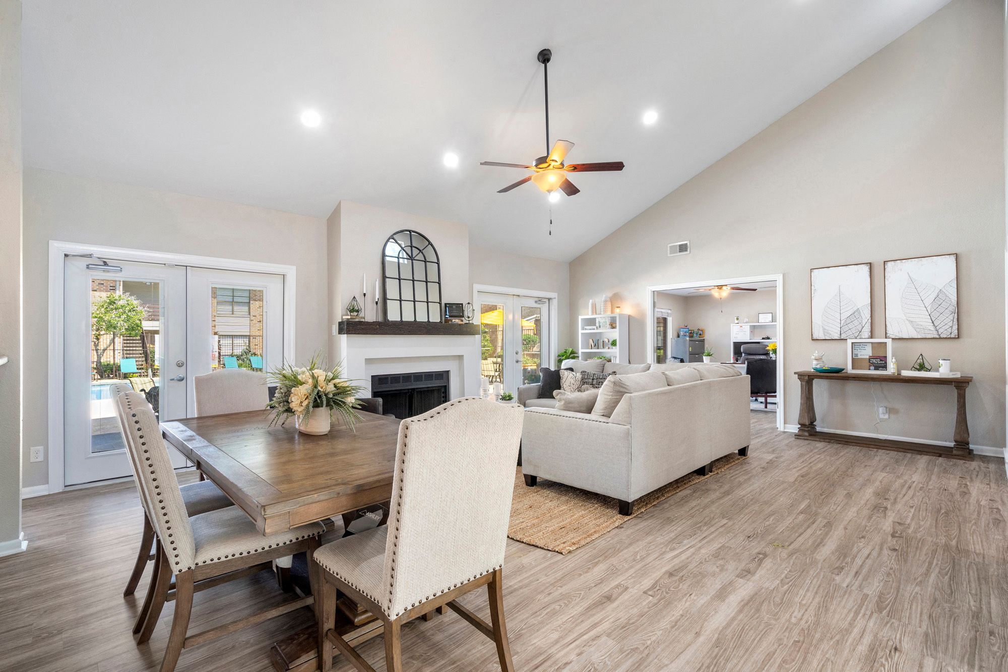 a living room with a dining room table and a fireplace
