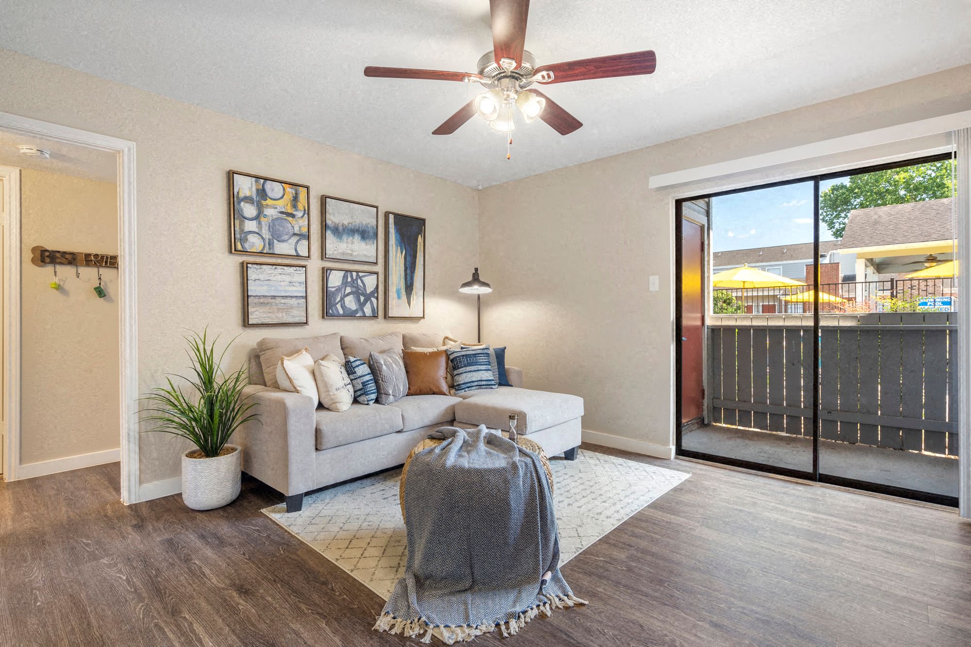 a living room with a couch and a ceiling fan