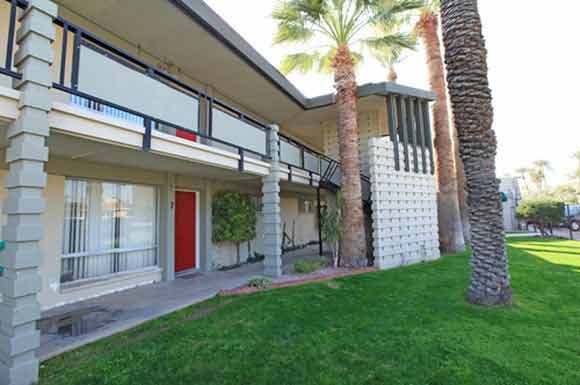 A house with a red door and a balcony.