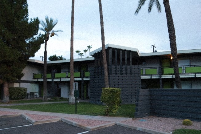 a large building with palm trees in front of it