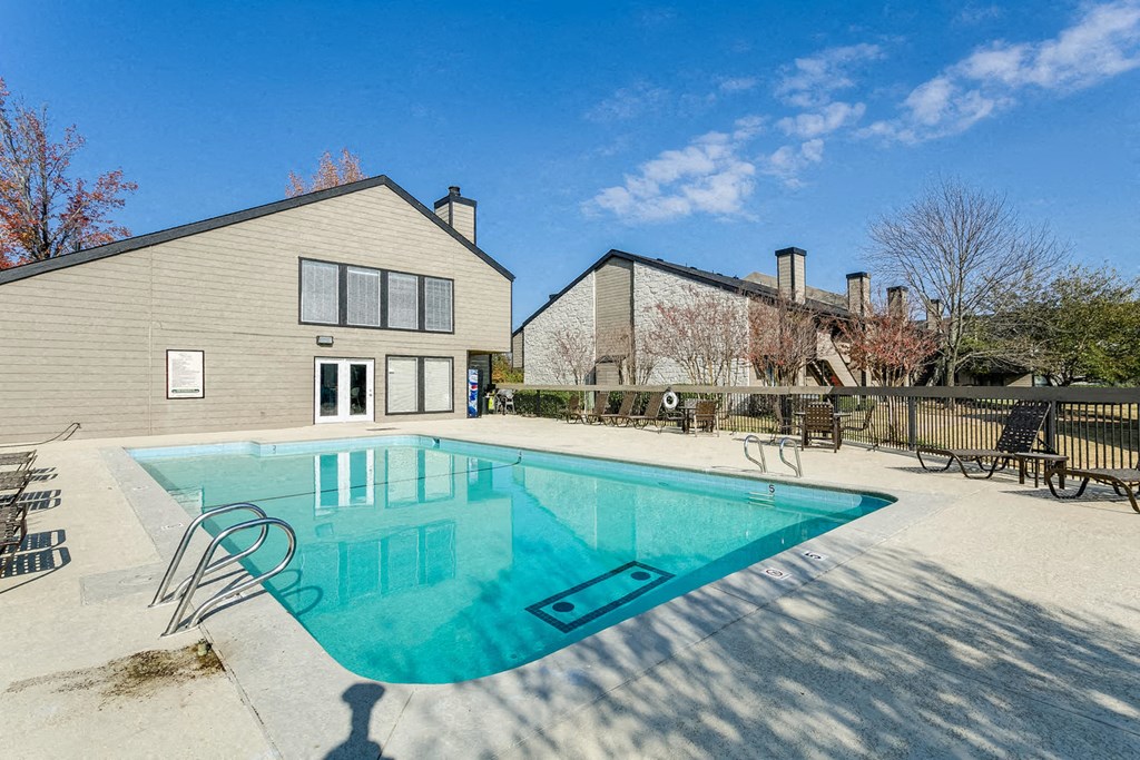 a pool with a house in the background