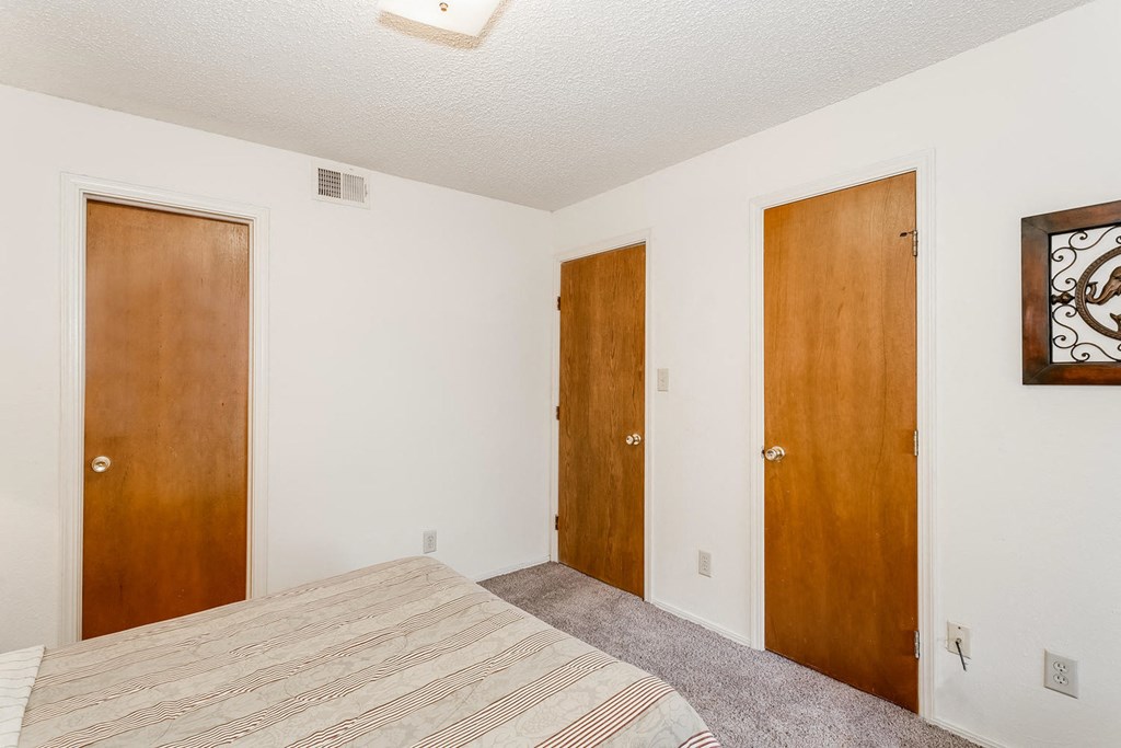 a bedroom with a bed and two doors