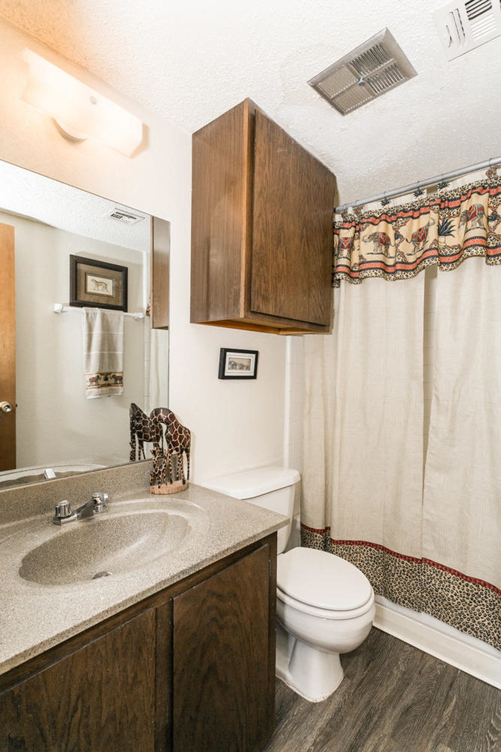 a bathroom with a toilet and a sink and a mirror