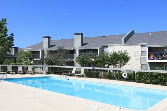 a swimming pool with a building in the background