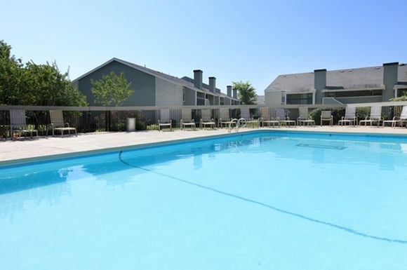 a large swimming pool in front of a building