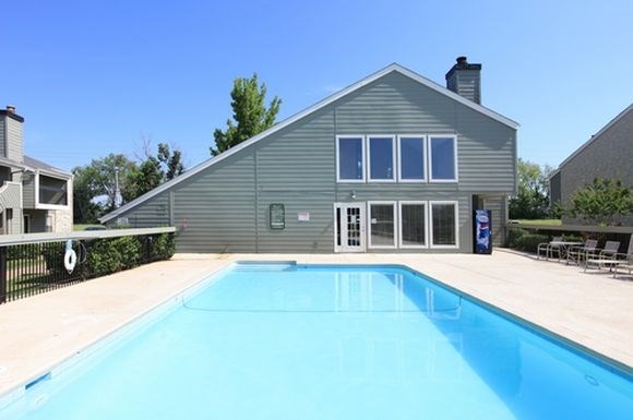 a large swimming pool in front of a house