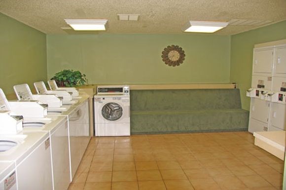a kitchen with a washing machine and a couch